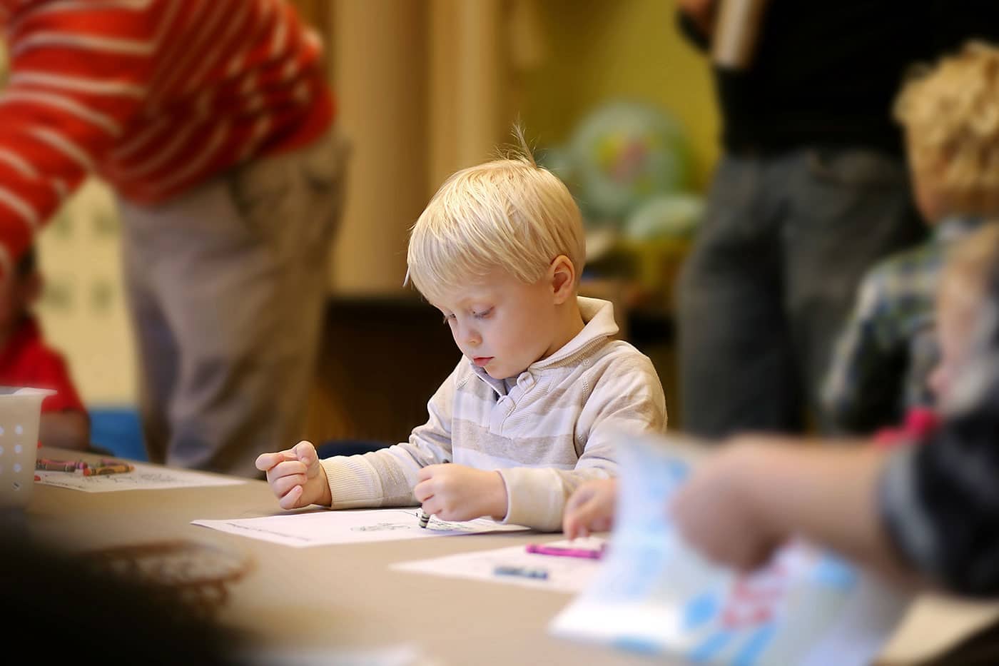 Little boy coloring with crayons